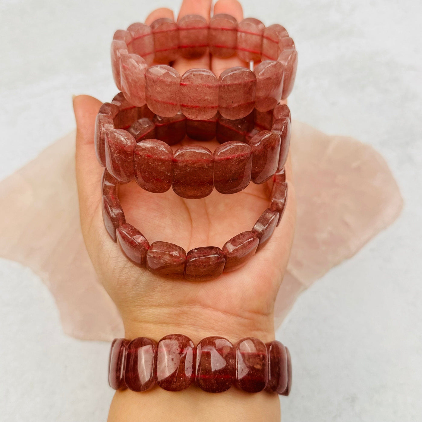 Strawberry Quartz Bracelets in hand for size reference 