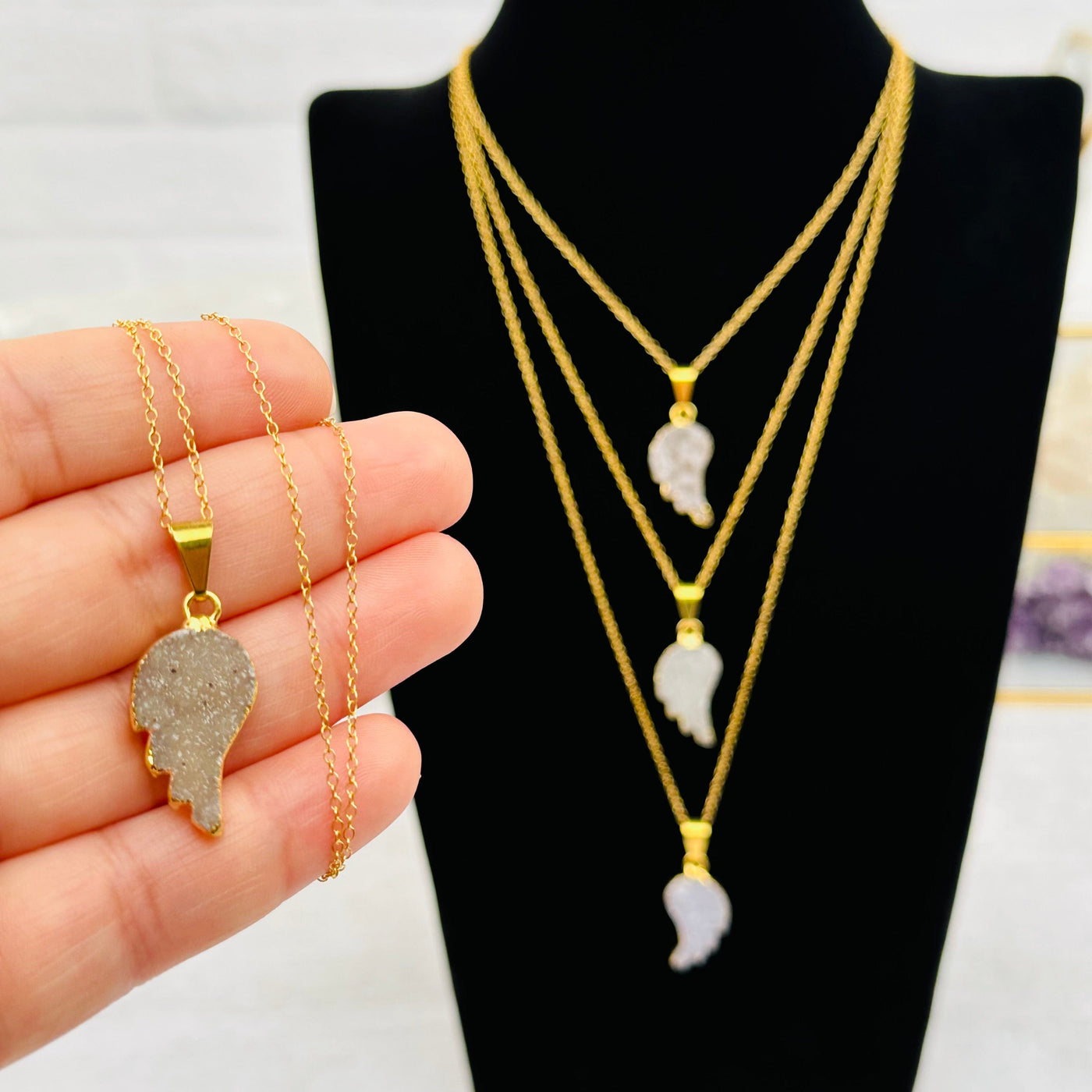 Druzy Angel Wing Necklace in hand for size reference 