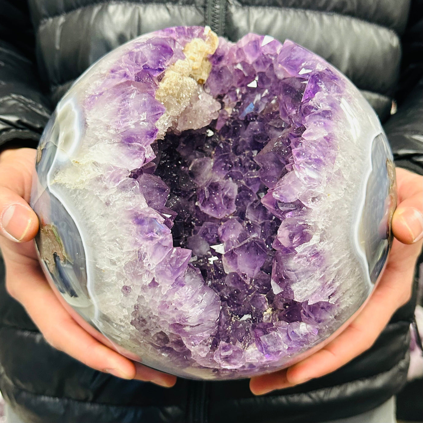 amethyst sphere in hand for size reference 