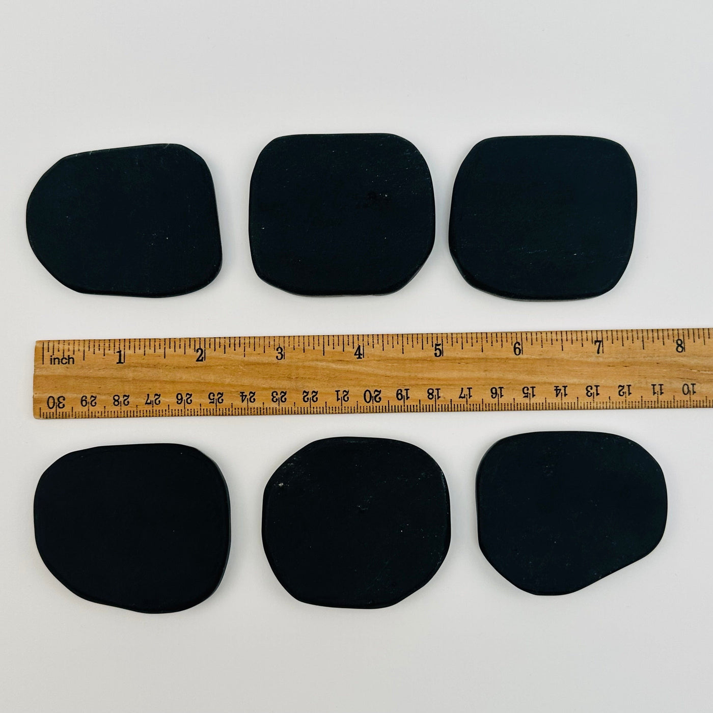 obsidian name cards displayed next to a ruler for size reference 