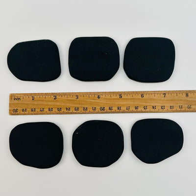 obsidian name cards displayed next to a ruler for size reference 