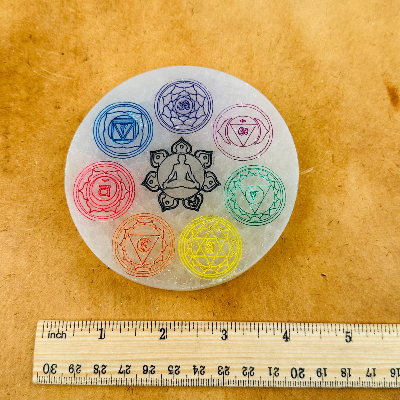Selenite Charging Plate - Engraved Colorful Chakra - 10cm - next to a ruler for size reference 