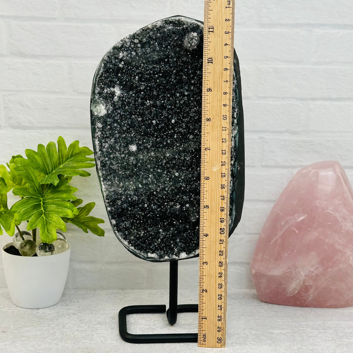 Black Amethyst Crystal Cluster on Metal Stand next to a ruler for size reference 