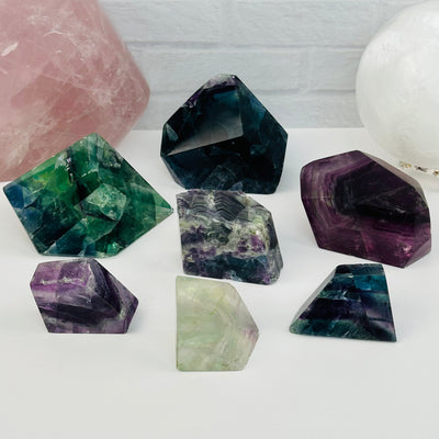 multiple fluorite free forms displayed to show the differences in the sizes and color shades 
