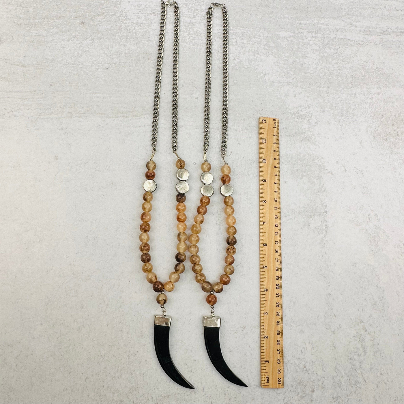 necklaces next to a ruler for size reference 