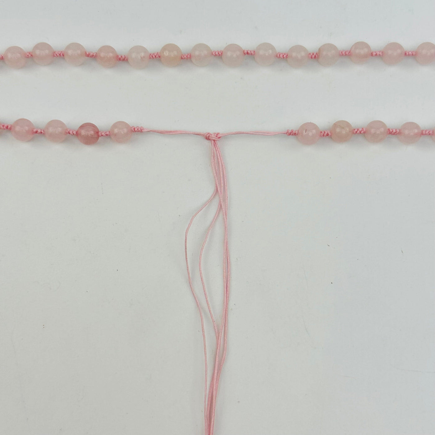 close up of the tie end of the mala necklace 