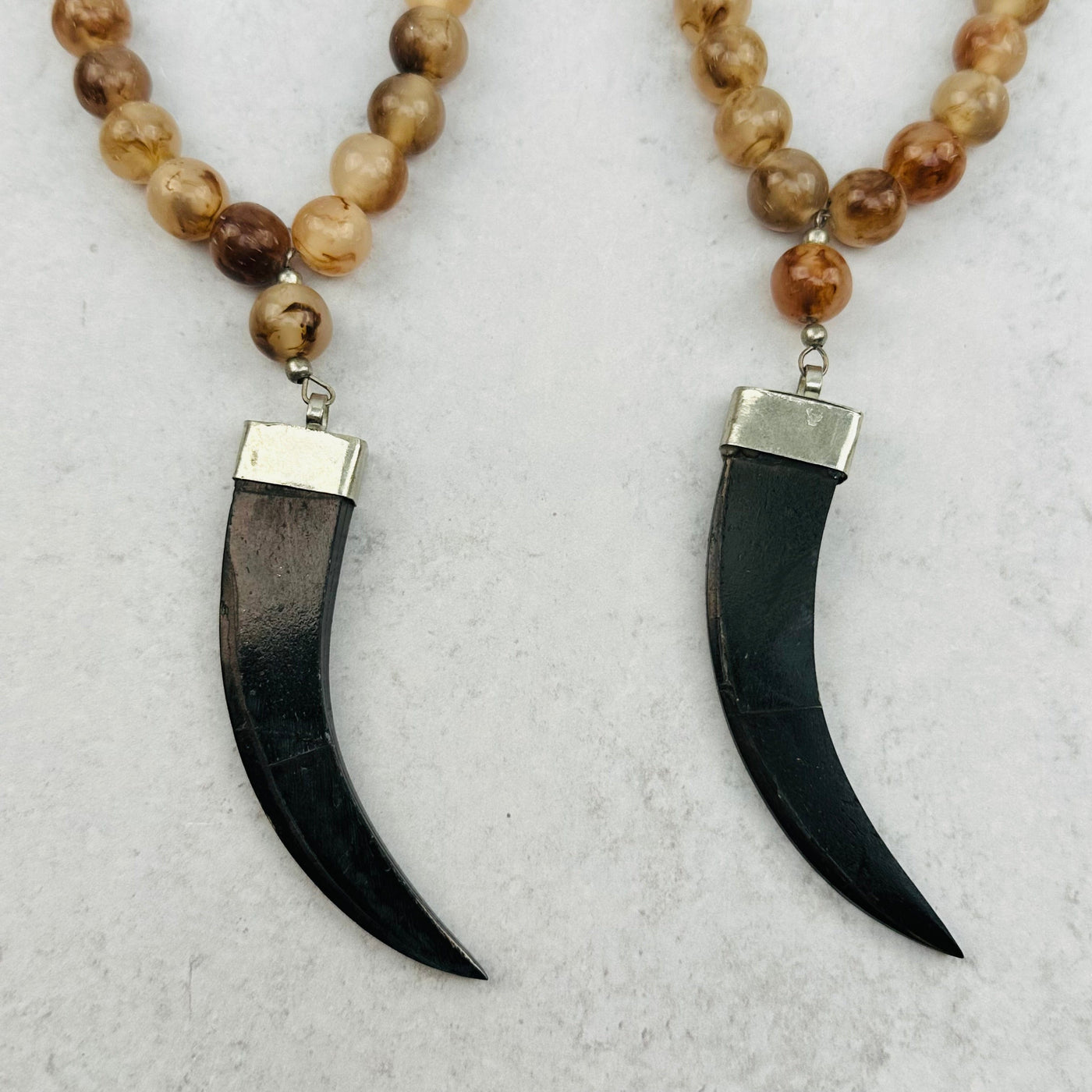 close up of the black horn pendants 