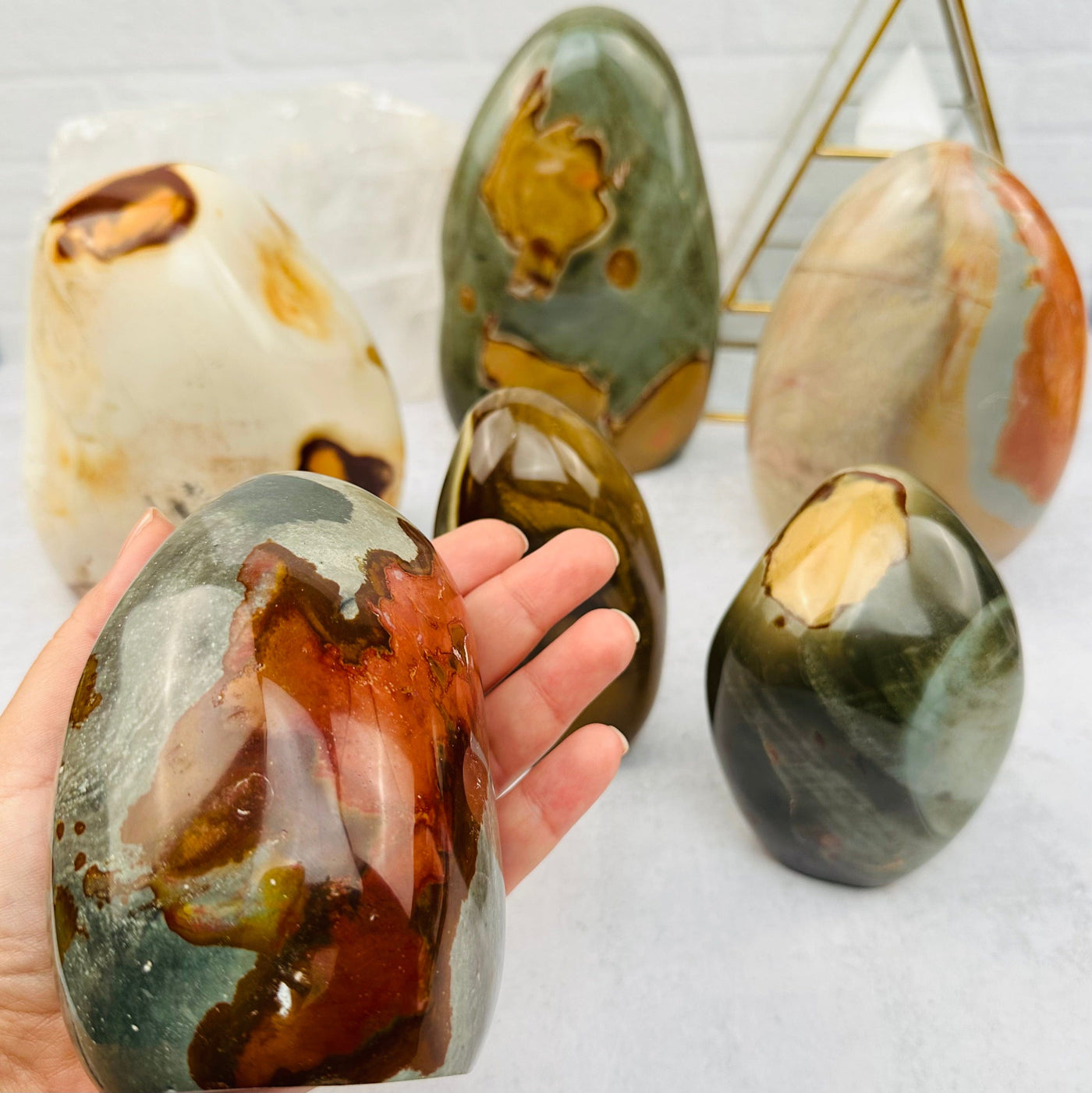Polychrome Jasper Cut Base in hand for size reference 