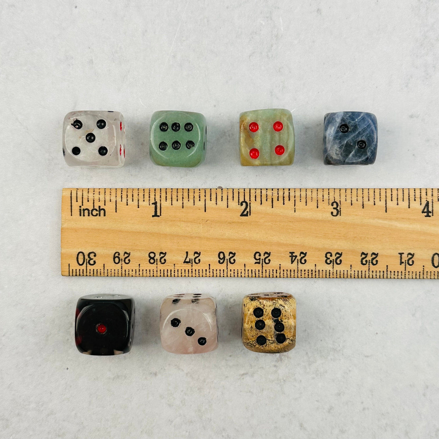 Gemstone Dice next to a ruler for size reference 