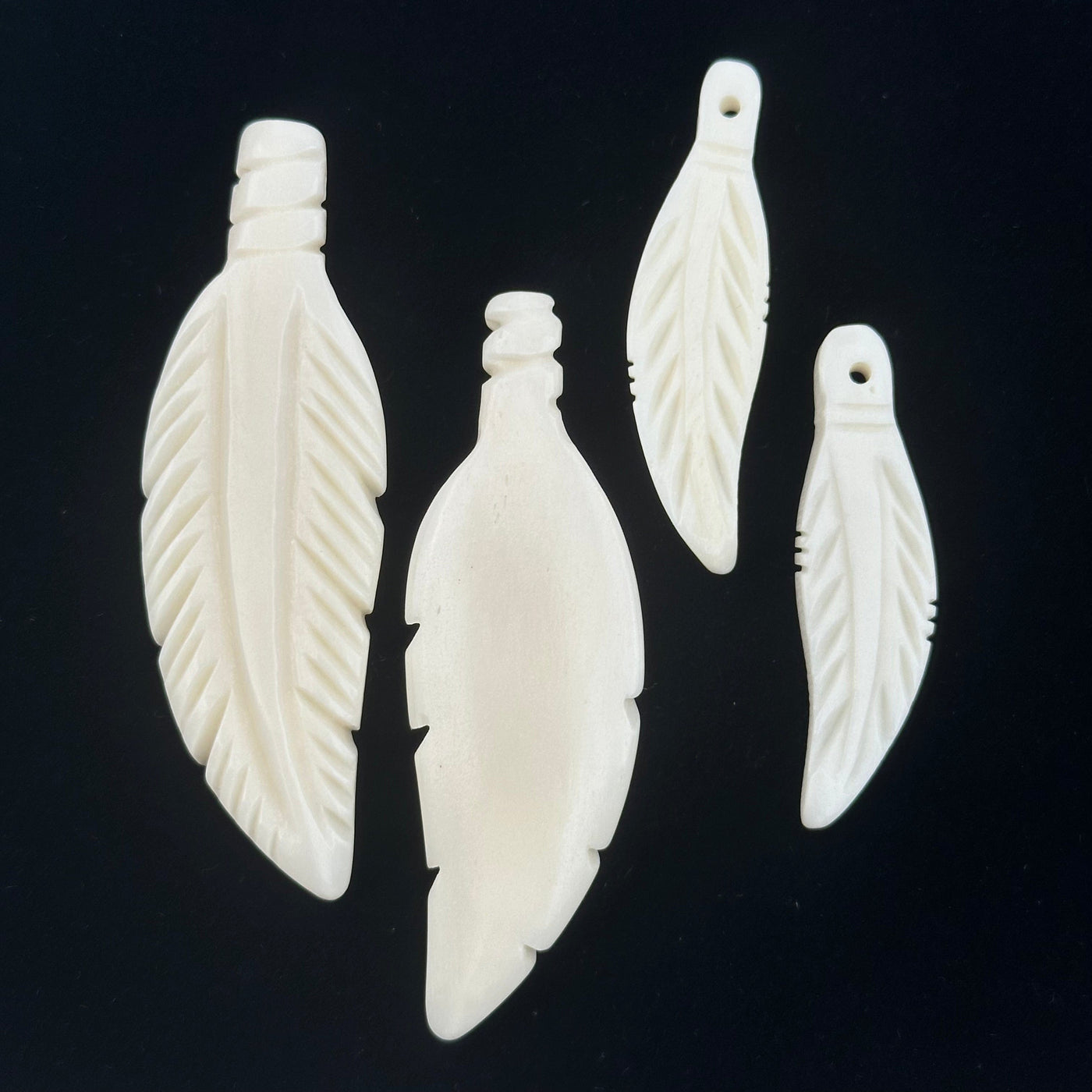 close up of the details on the front and back of these pendants 