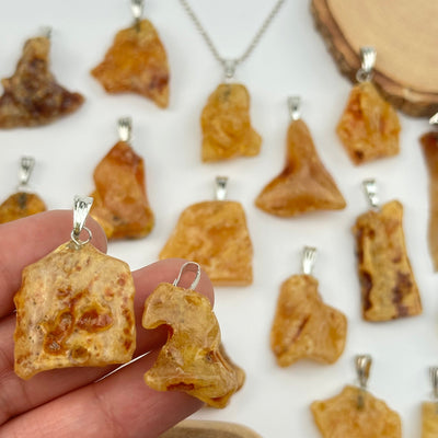 close up of the details on these amber pendants