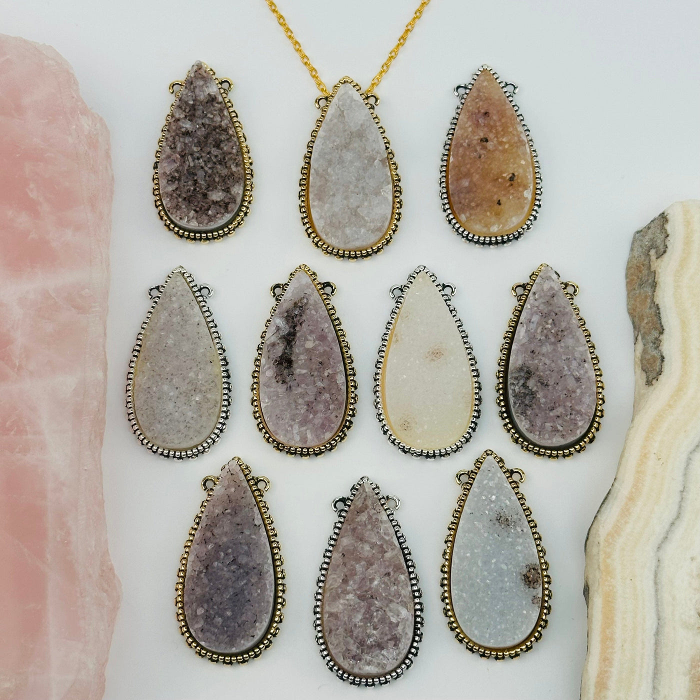 multiple pendants displayed to show the differences in the druzy color shades 