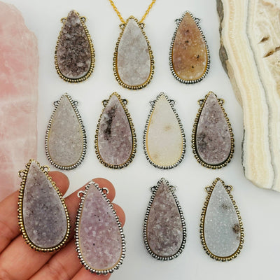 druzy drop pendants in hand for size reference 