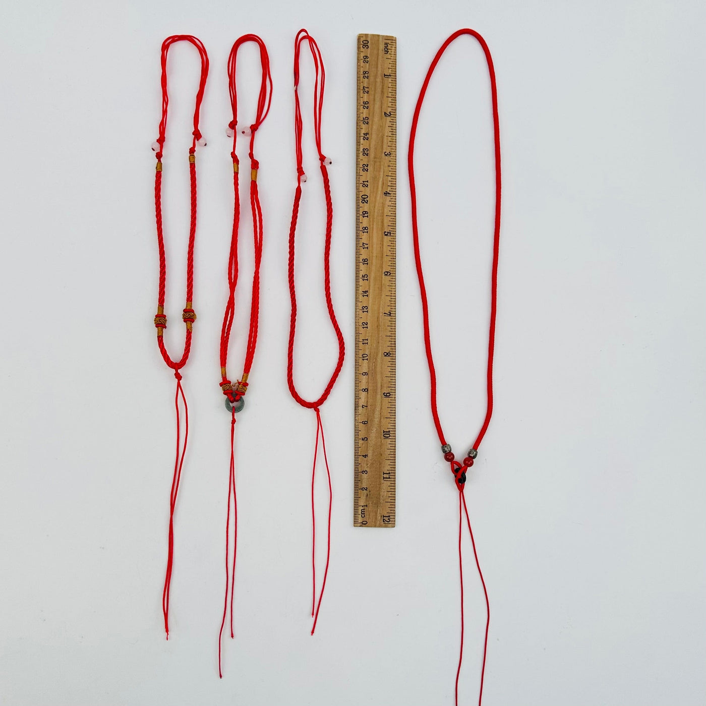 necklaces next to a ruler for size reference 