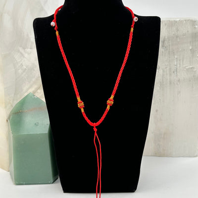 necklace displayed to show how it hangs. available with a gold knot