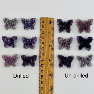 amethyst cabochons displayed next to a ruler for size reference 