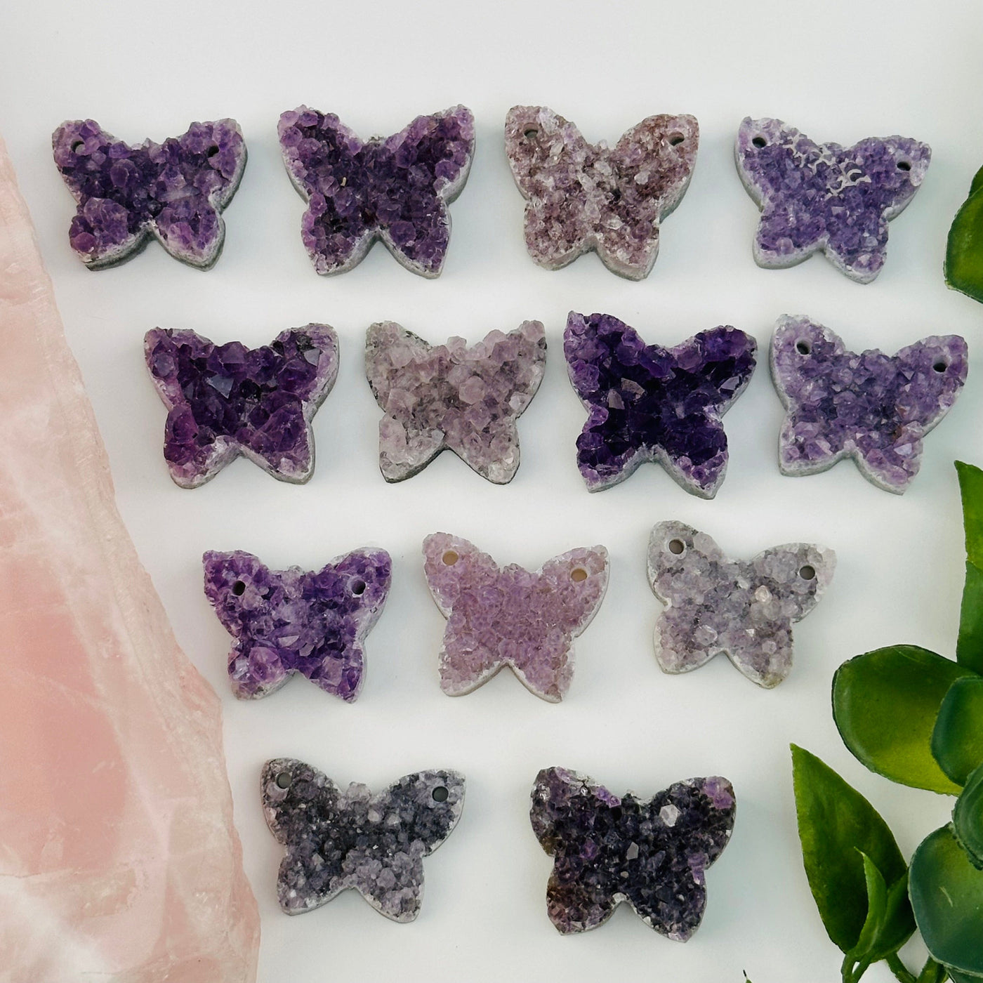 multiple amethyst crystal cabochons displayed to show the differences in the sizes and color shades 