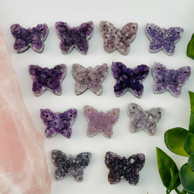 multiple amethyst crystal cabochons displayed to show the differences in the sizes and color shades 