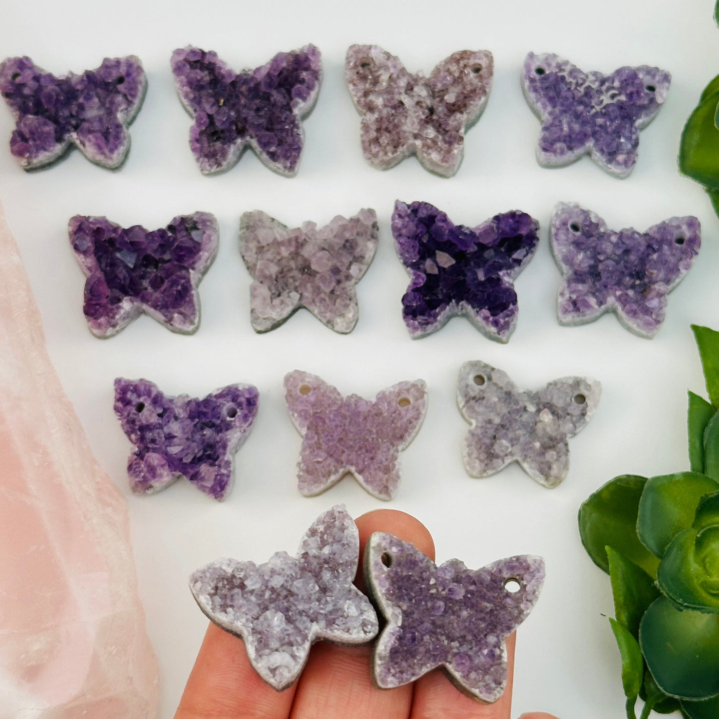 multiple amethyst crystal cabochons displayed to show the differences in the sizes and color shades 