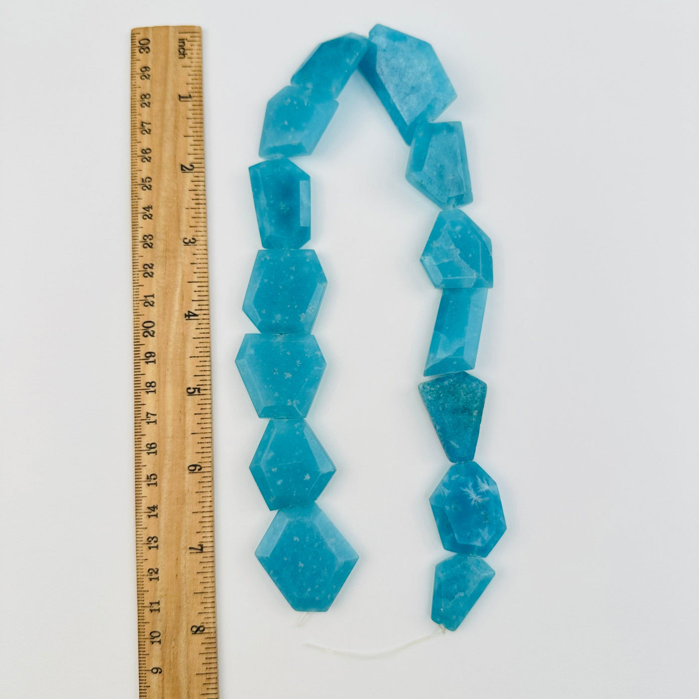 beads next to a ruler for size reference 