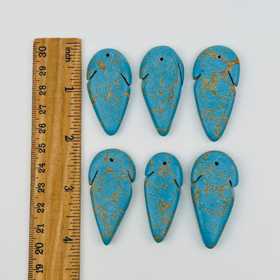 beads next to a ruler for size reference 