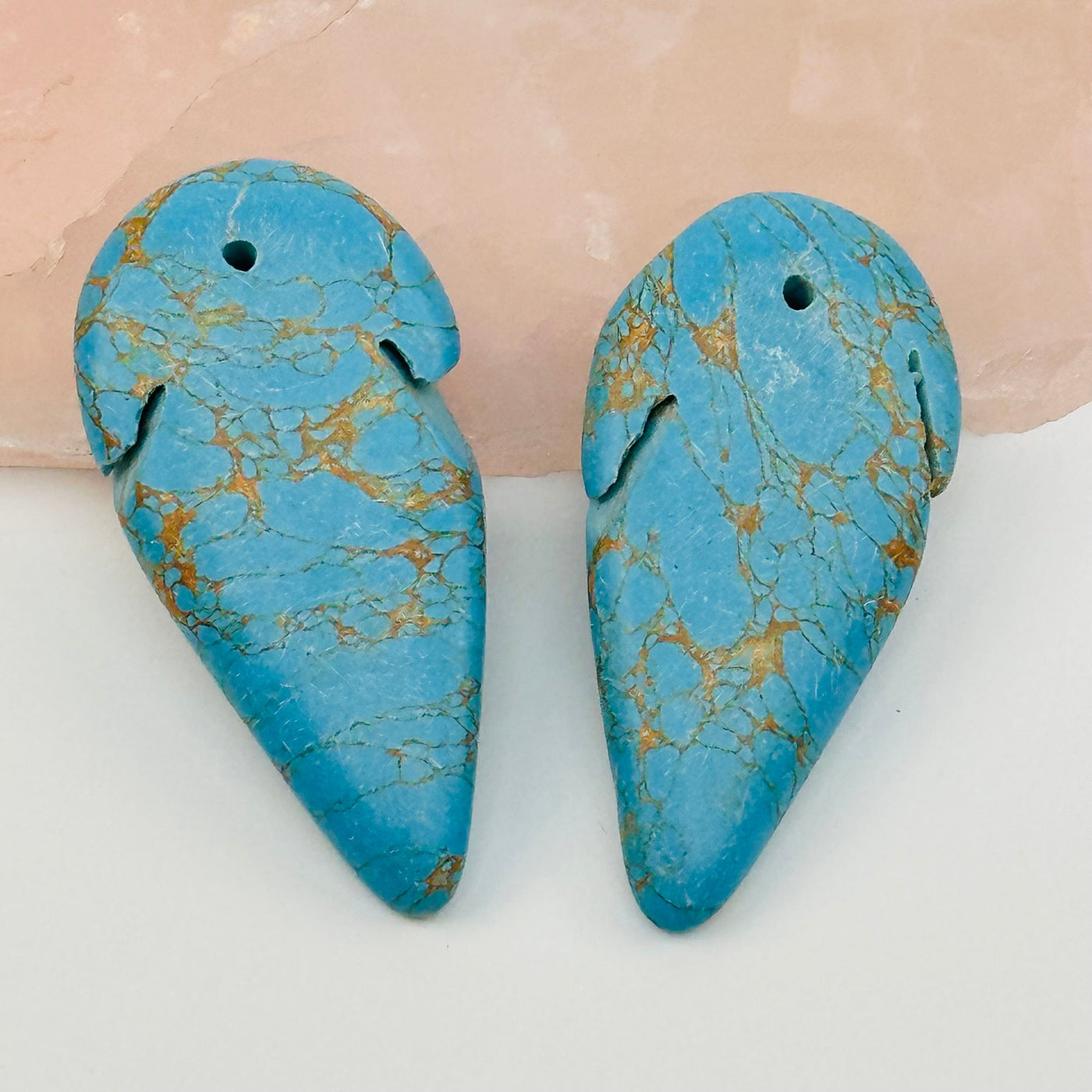 close up of the details on there turquoise arrowhead bead