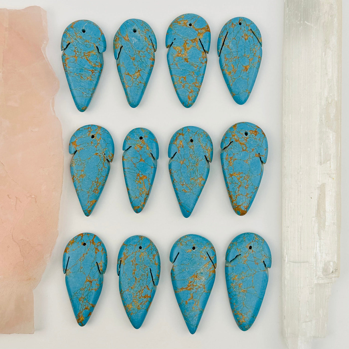multiple turquoise beads displayed to show the differences in the sizes 