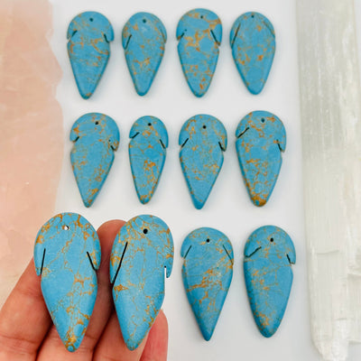 turquoise beads in hand for size reference 