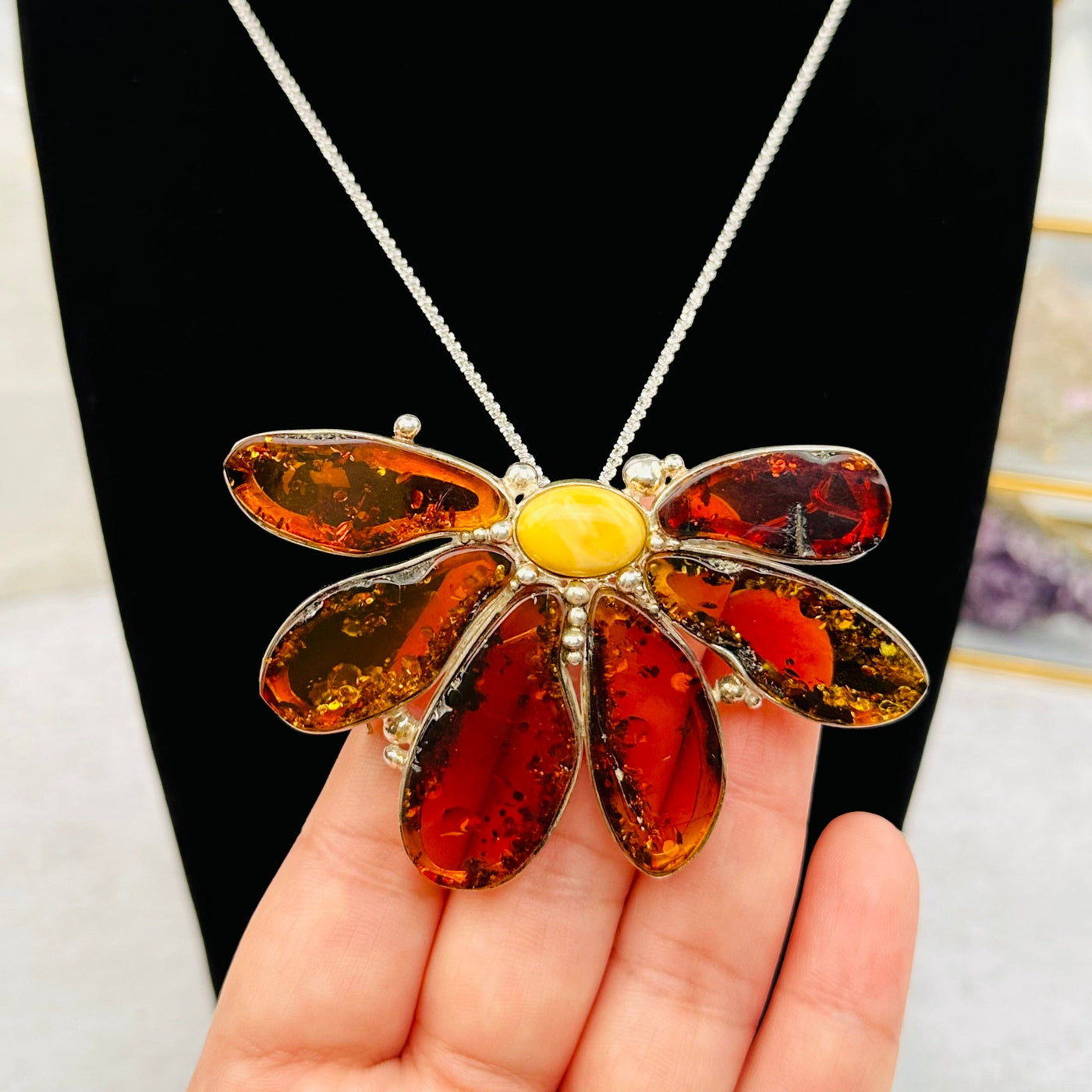 Baltic Amber Flower Pendant and Broche in hand for size reference 