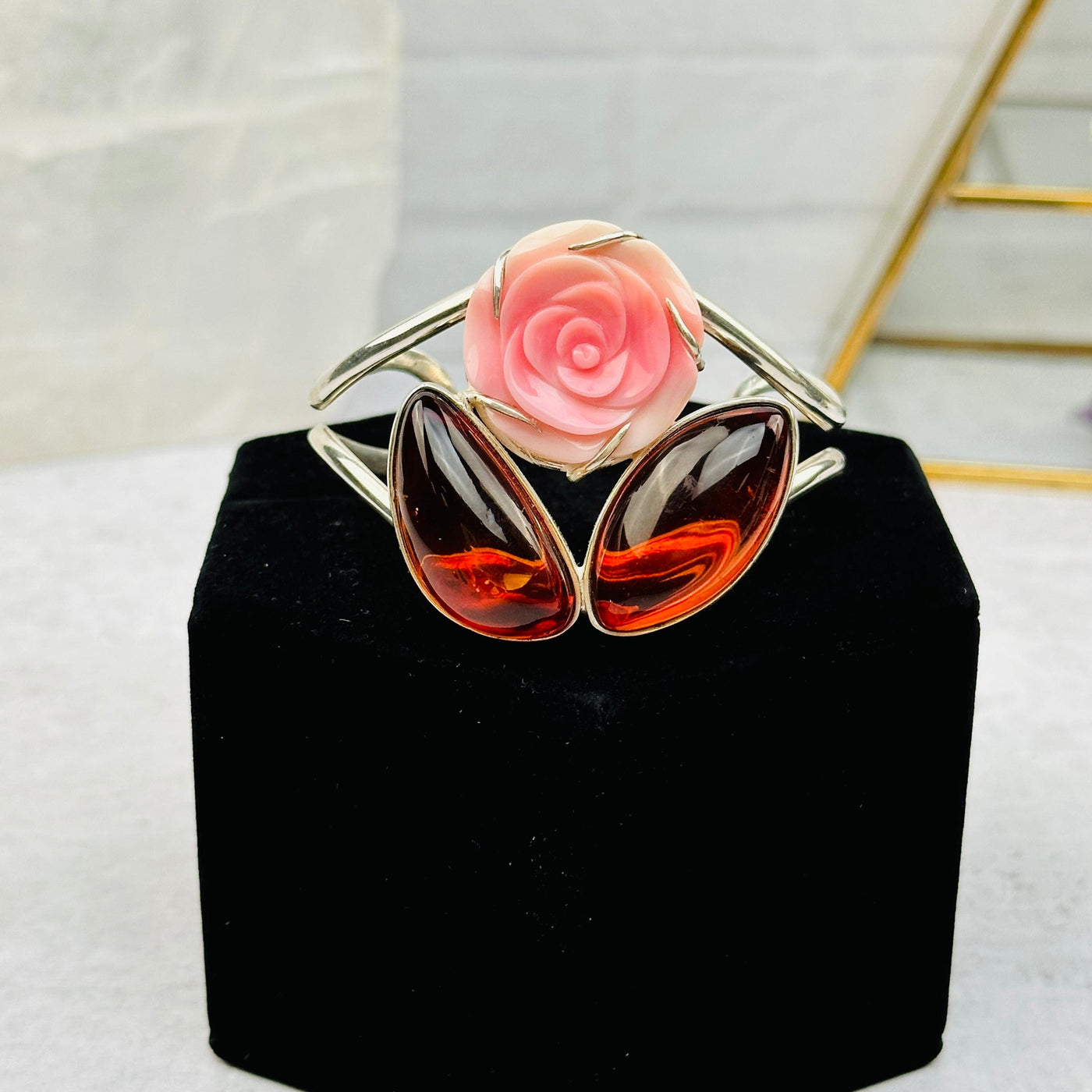 darker amber bracelet with pink rose accent 
