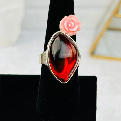 close up of the amber ring with a pink rose accent