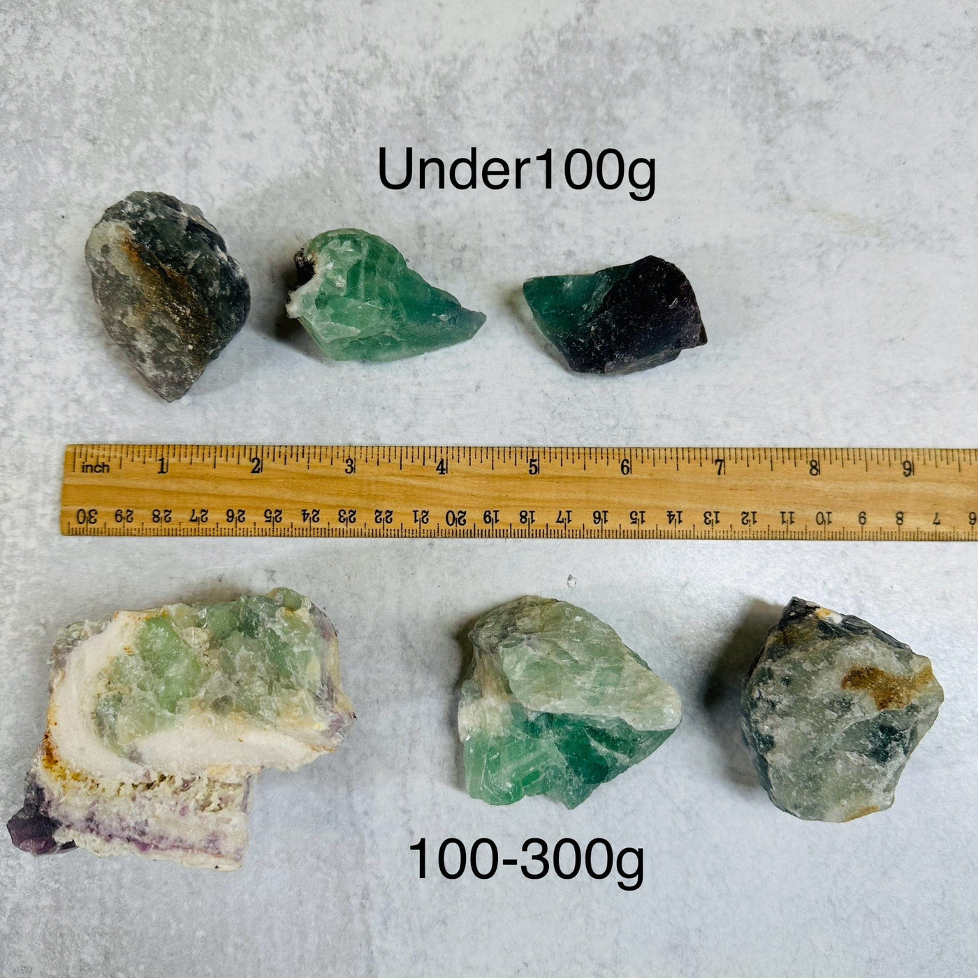 Fluorite Rough Stone - By Weight next to a ruler for size reference 