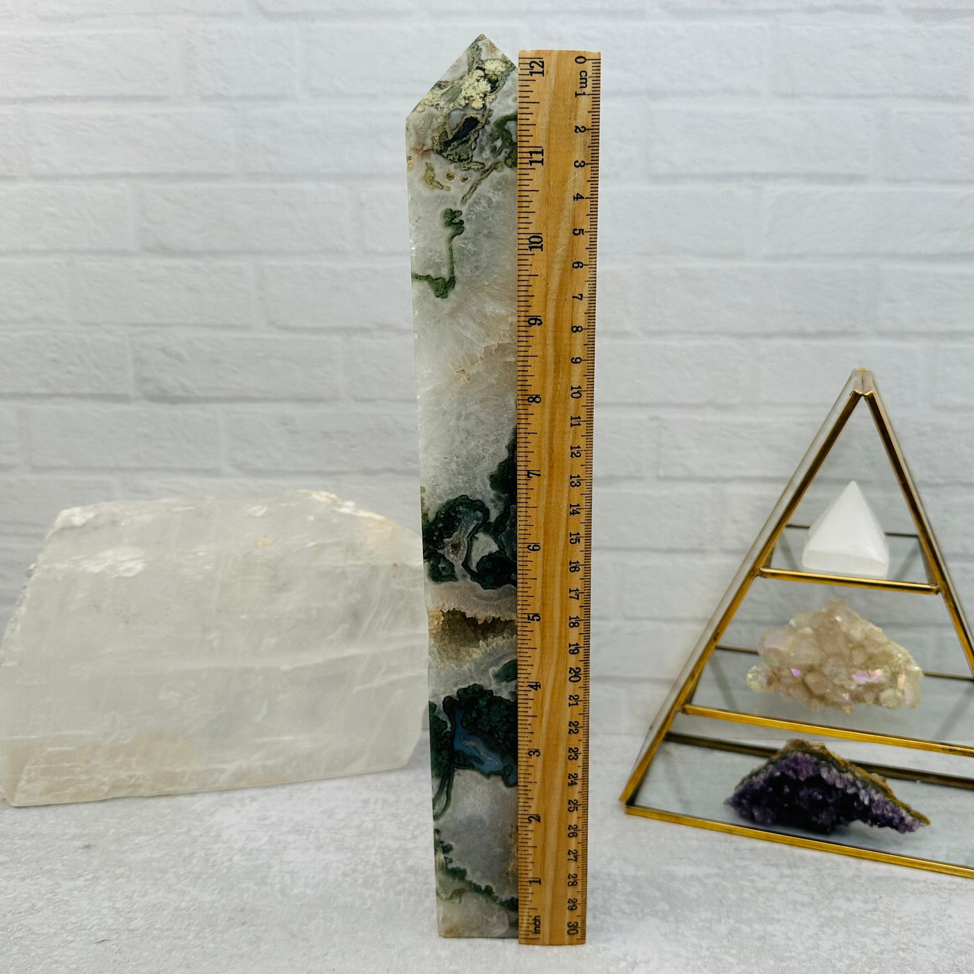 Moss Agate Polished Obelisk next to a ruler for size reference 