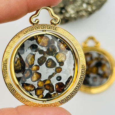 close up of this Sericho Pallasaite Meteorite Crystal Pendant
