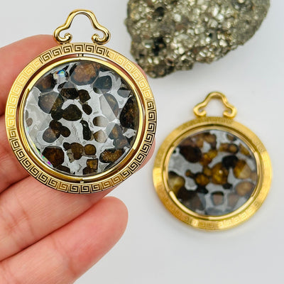 Sericho Pallasaite Meteorite Crystal Pendant in hand for size reference 