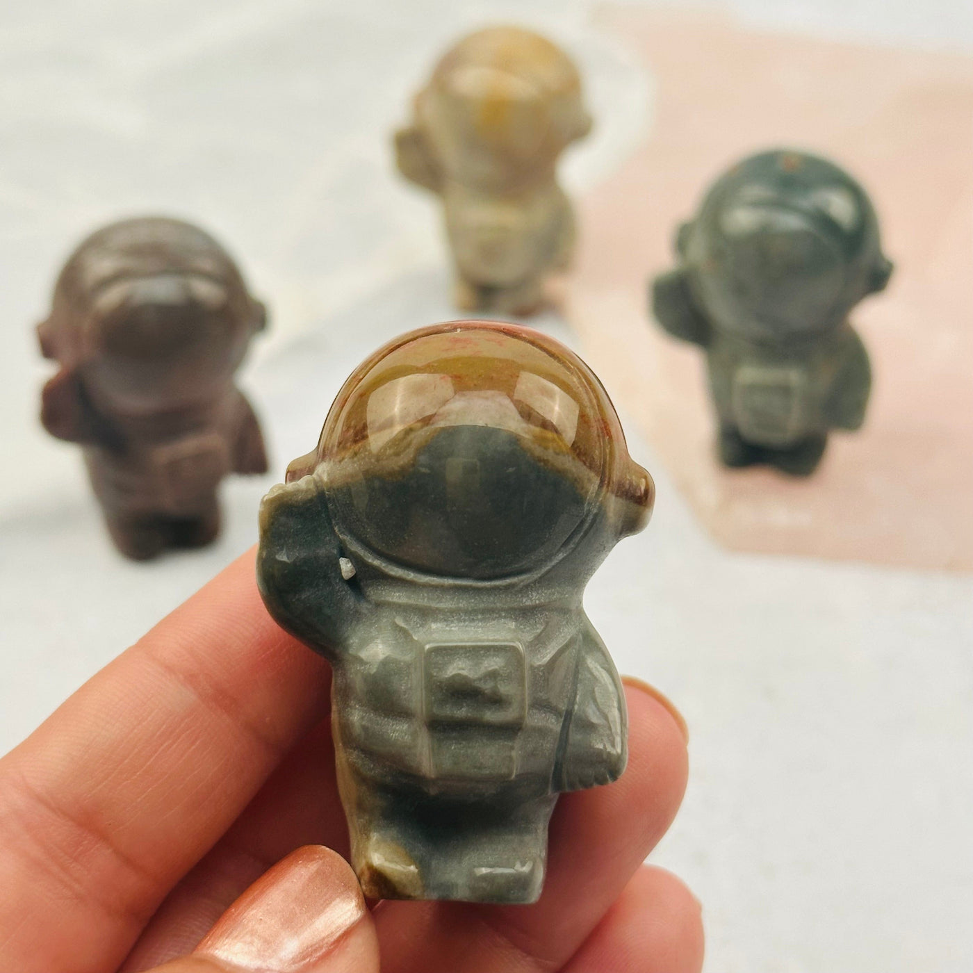 Polychrome Jasper Carved Astronaut in hand for size reference 