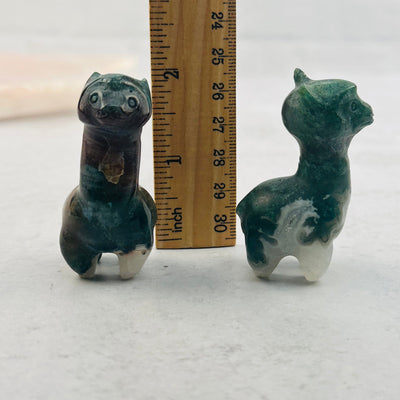 Carved Gemstone Alpaca next to a ruler for size reference 