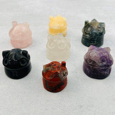 multiple carved gemstone houses displayed to show the differences in the color shades and sizes 
