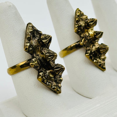 close up of the details on these brass fashion rings 