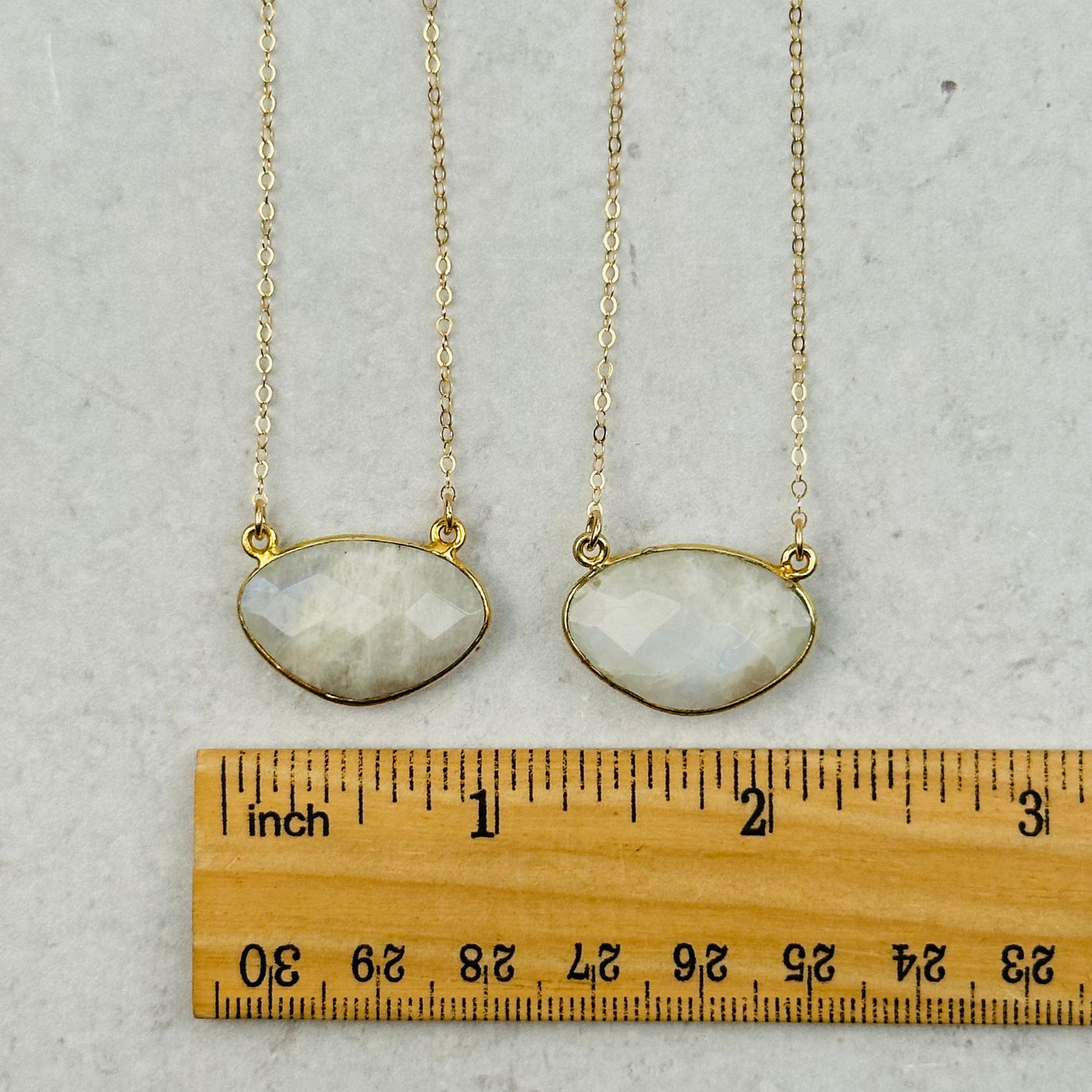 pendants next to a ruler for size referenece 
