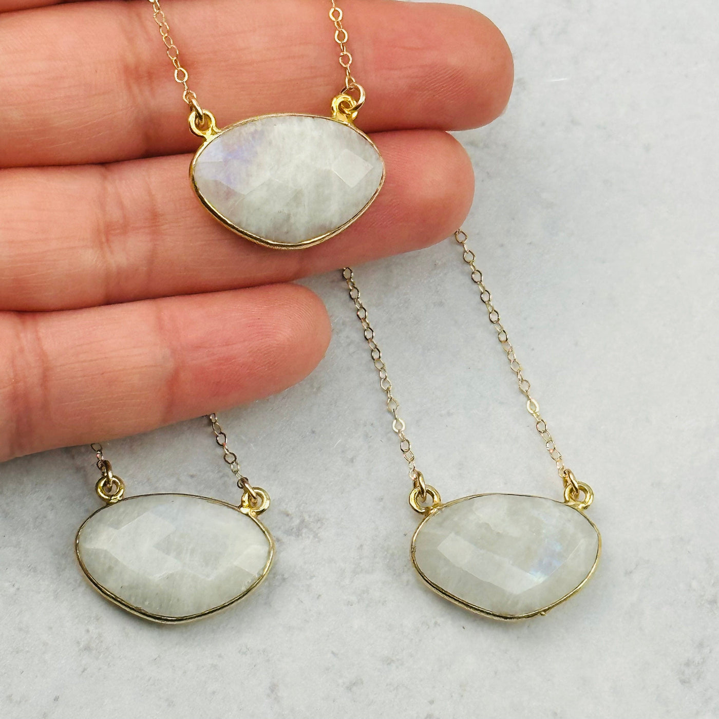 close up of the details on these faceted moonstone necklace pendants 