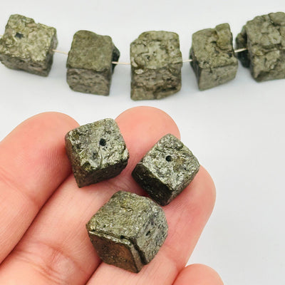 Pyrite Cube Beads Rough Stone - Center Drilled in hand for size reference 