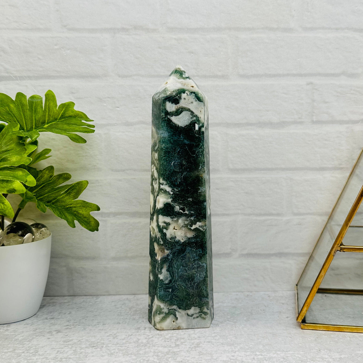 Moss Agate Tower Point displayed as home decor 