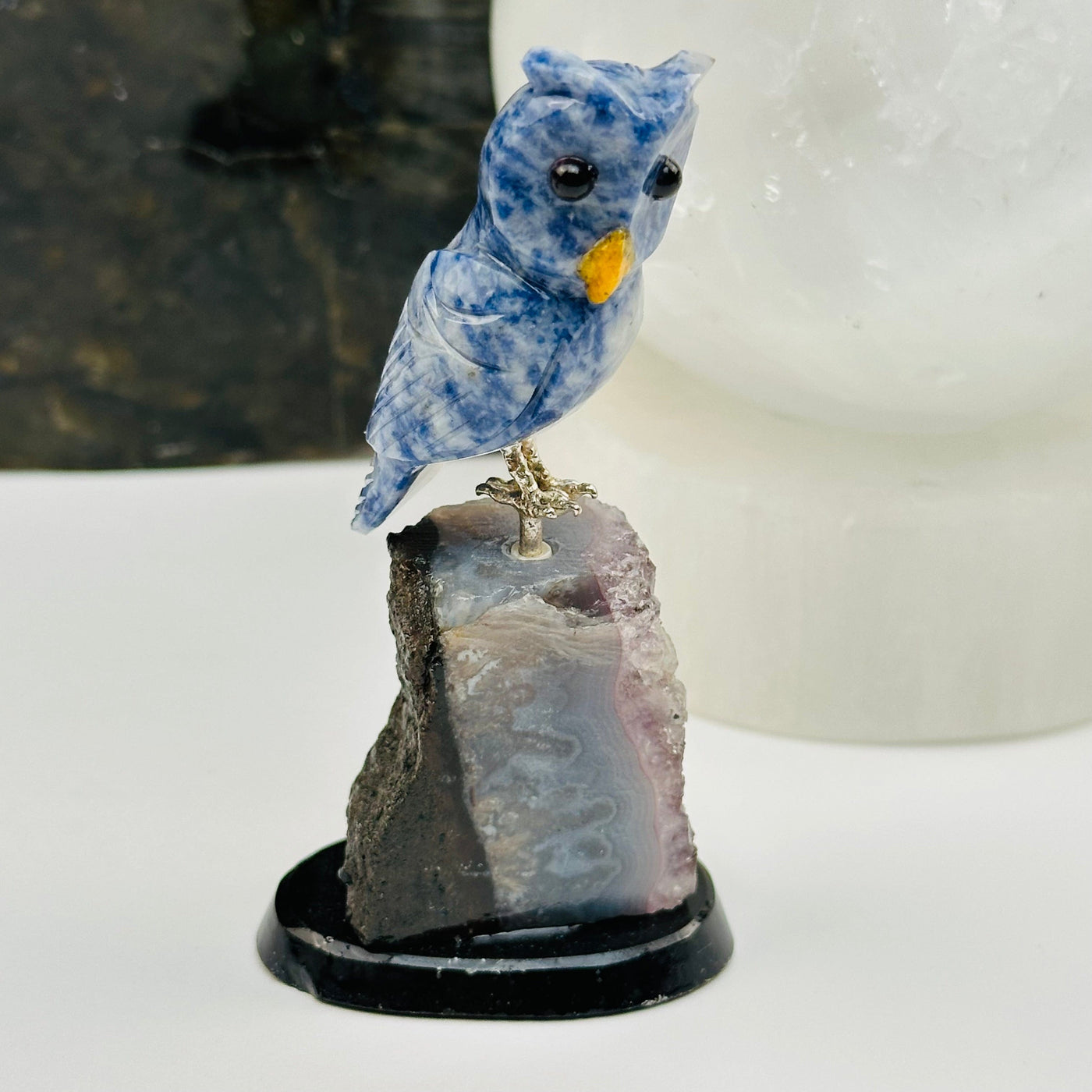 sodalite owl on amethyst crystal base displayed as home decor 