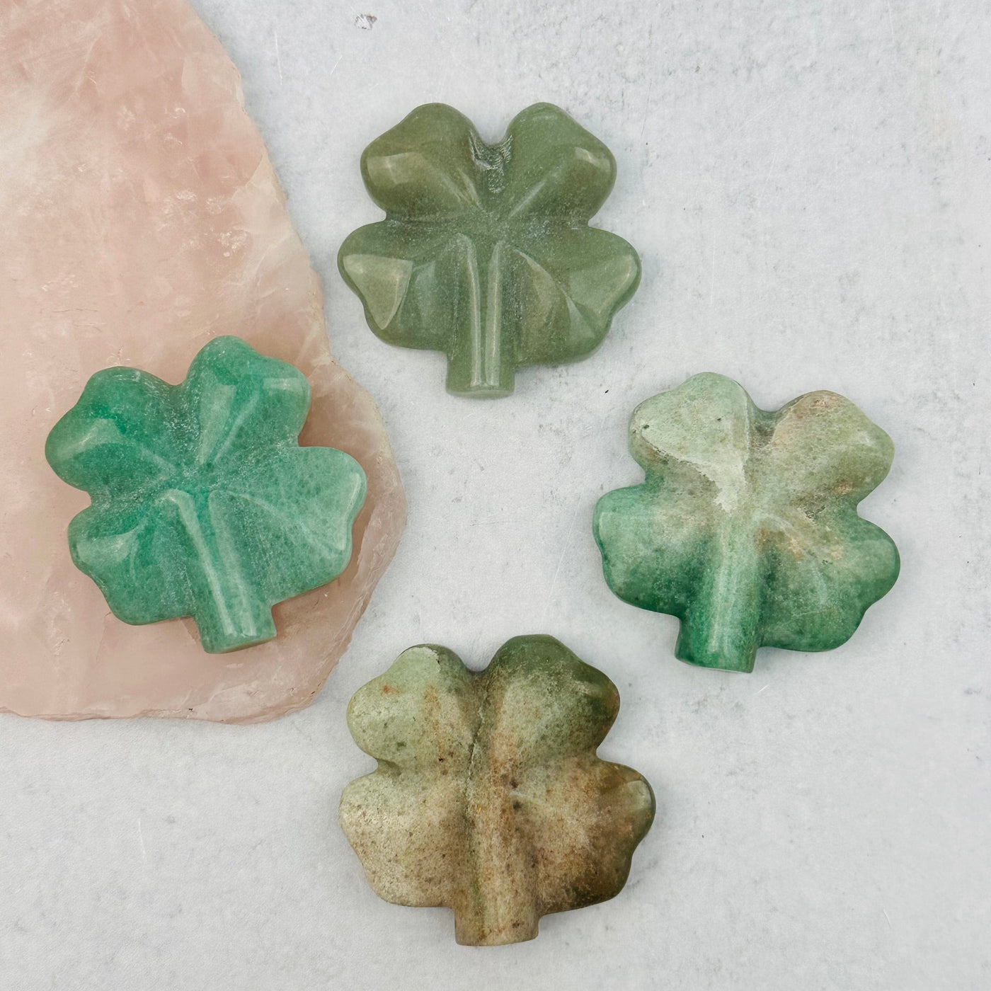 multiple aventurine carved gemstones displayed to show the differences in the color shades 