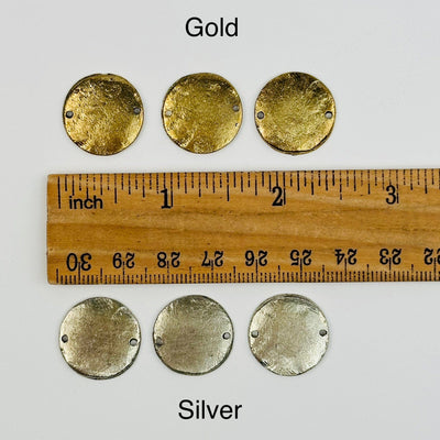 charms next to a ruler for size reference 