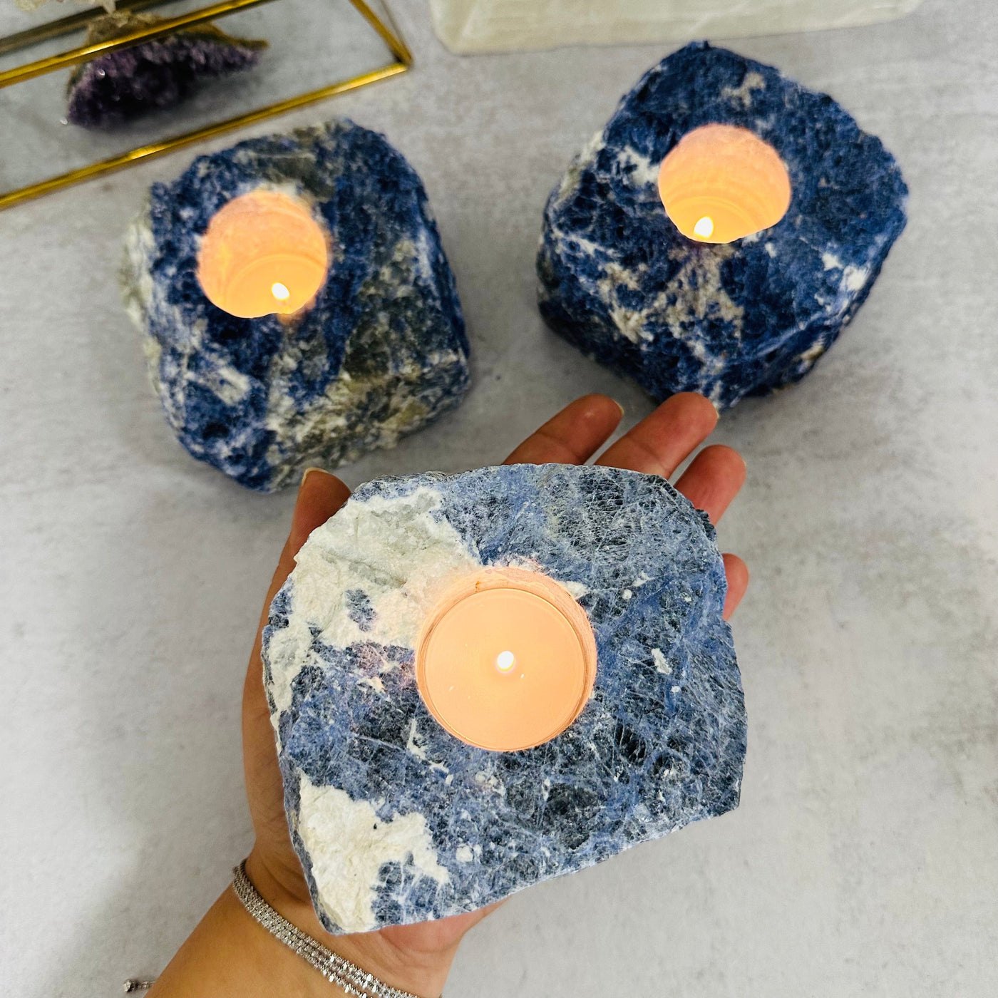 Sodalite Candle Holder in hand for size reference 