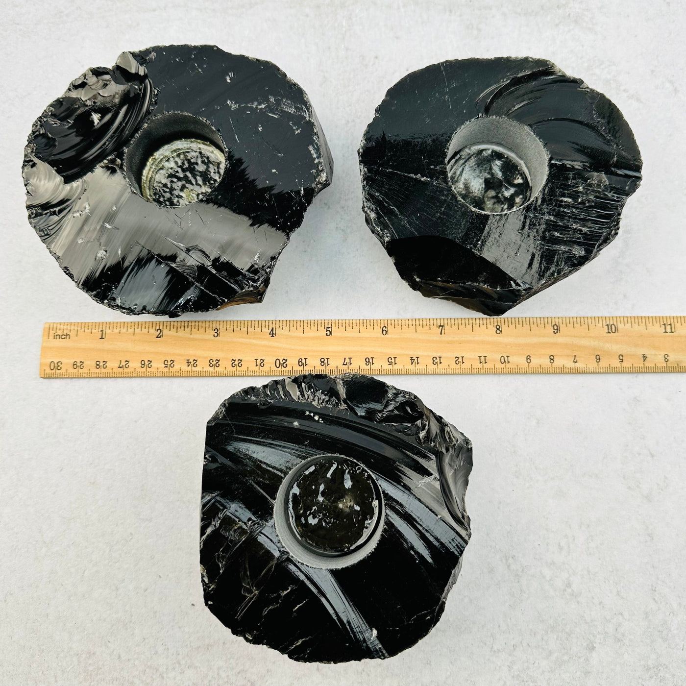 Obsidian Candle Holders next to a ruler for size reference 