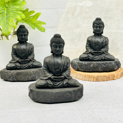 multiple sitting buddhas displayed to show the slight differences in the sizes and color shades 