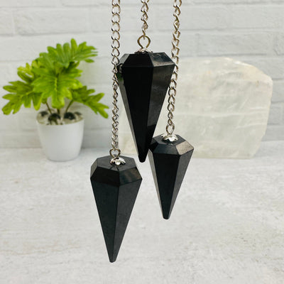 close up of the details on these shungite pendulums 